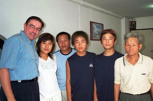 Rev. Tim Peters stands next to a North Korean family of refugees